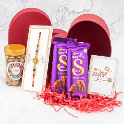 Round pearl rakhi with Almond and Silk chocolates in heart shape box